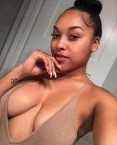Afro-Latina woman in beige low-cut top smiling seductively – Luna Rae