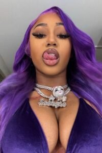 Seductive woman with long purple hair and tongue out pose – adult phone chat UK profile.