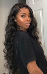 Nyla Storm, sexy ebony woman with long black hair, posing in a black top