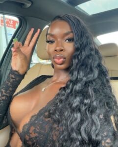 Zaria Vixen – Caribbean woman in black lace top posing for sexy phone chat promotion in UK