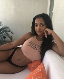 Chill and sexy Caribbean girl Nia Sway lounging in crop top and panties for adult phone chat