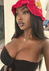 Nyah Rose – Caribbean woman in black top with red crochet hat posing seductively in London UK