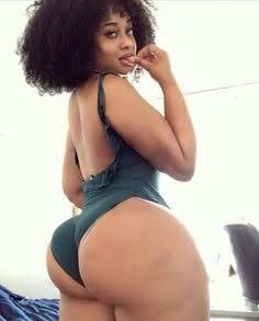Aaliyah Storm – Curvy Caribbean woman in green bodysuit posing seductively indoors in London UK