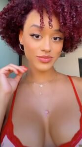 Red-haired Caribbean girl Mimi Flame in lingerie teasing for adult phone chat in the UK