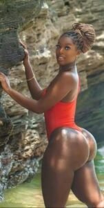 Imani Rose – Curvy Caribbean woman in red swimsuit posing seductively by the rocks in Manchester UK