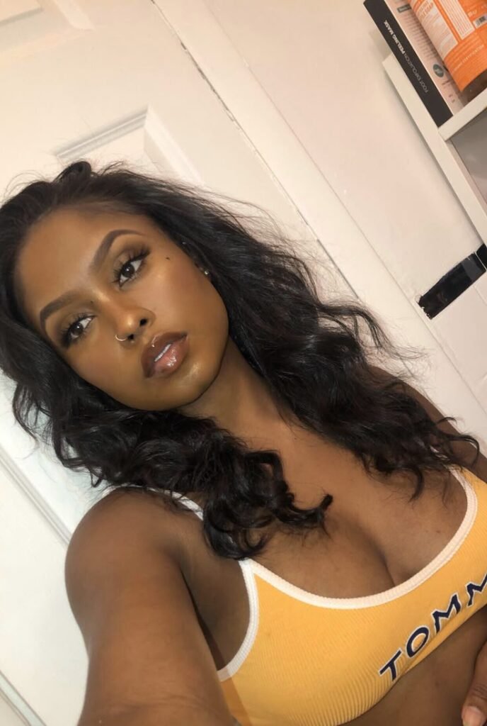 Amara Gold – Curvy black woman in yellow bra posing seductively for phone chat promo