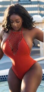 Sasha Flame – Curvy Caribbean woman in red swimsuit stepping out of the pool seductively in Manchester UK