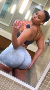 Naomi Fierce – ebony fitness goddess in tight shorts posing in the mirror
