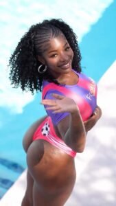 Tiana Starr – Caribbean football fantasy babe in pink bodysuit by the pool
