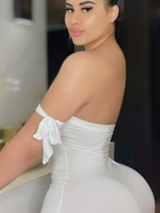 Latina goddess in tight white dress posing seductively