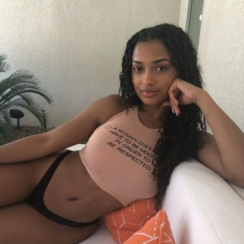 Chill and sexy Caribbean girl Nia Sway lounging in crop top and panties for adult phone chat