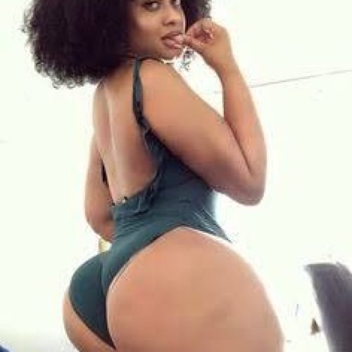 Aaliyah Storm – Curvy Caribbean woman in green bodysuit posing seductively indoors in London UK