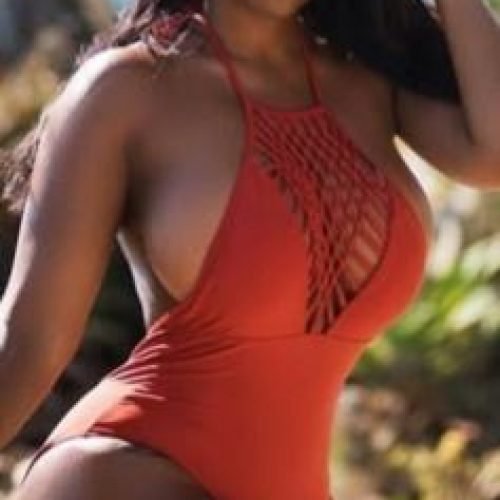 Kiara Flame – Caribbean woman in orange swimsuit posing seductively in Manchester UK