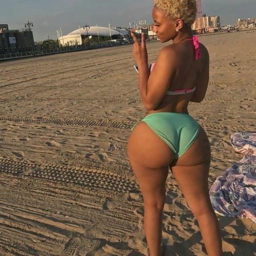 Luna Blaze – blonde Caribbean woman in green bikini posing on the beach