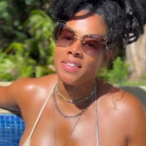 Zahara Luxe – Caribbean woman in bikini with natural dreadlocks relaxing in a pool in Birmingham UK
