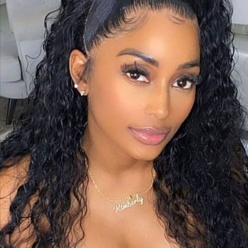 Gorgeous woman with curly hair and deep cleavage posing indoors – adult phone chat model Birmingham UK.