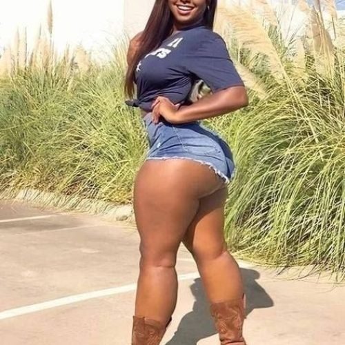Savannah Blaze – Curvy Caribbean woman in denim shorts and boots posing outdoors in London UK