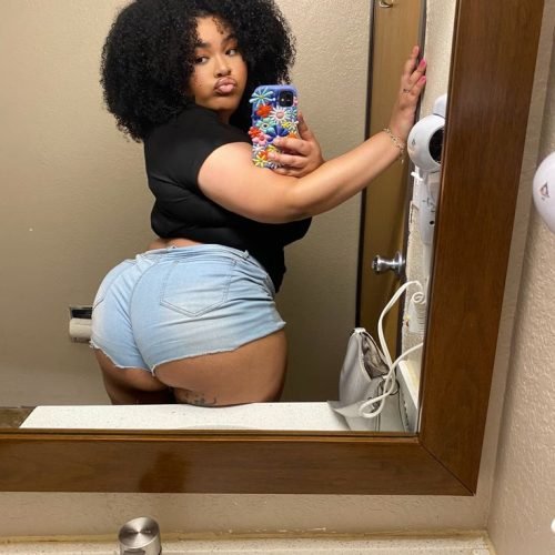 Kiana Frost – Curvy Caribbean woman in blue shorts taking a mirror selfie in London UK